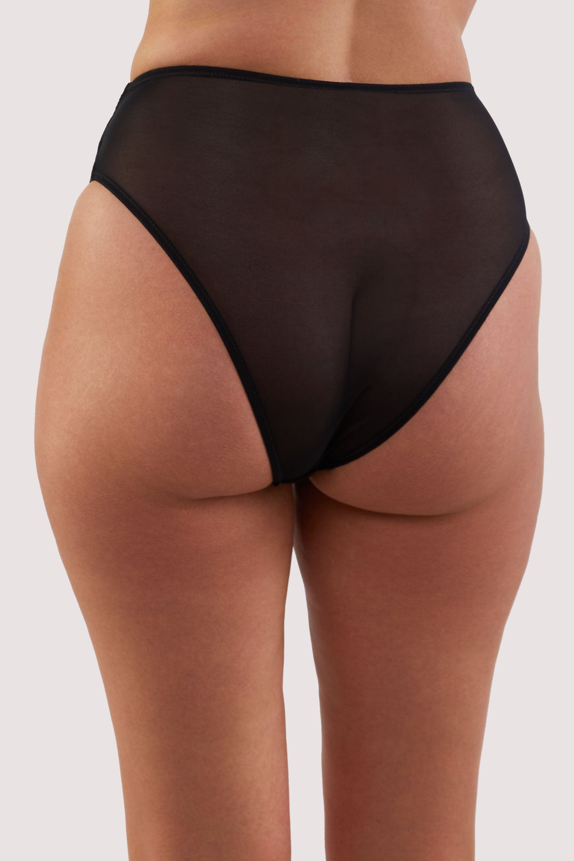 model shows black sheer mesh back of high-waisted briefs
