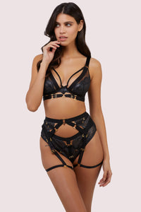 model wears black wet look lace lingerie set