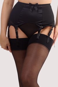 Model wears a black satin 8 Strap retro everyday suspender with six adjustable straps, soft and smooth finish with a matching brief.