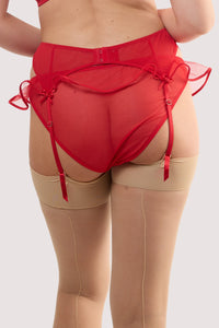 Model shows the back of a monica red ribbon slot lace suspender with hook and eye fastening.