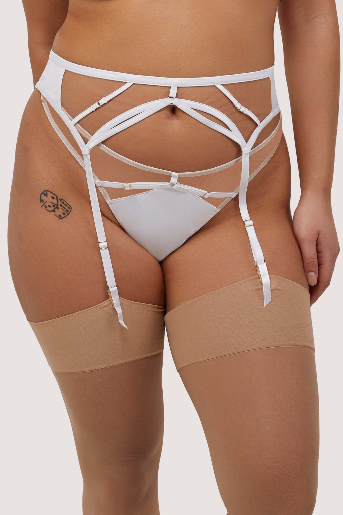 Model wears white strap detail suspender belt with matching thong