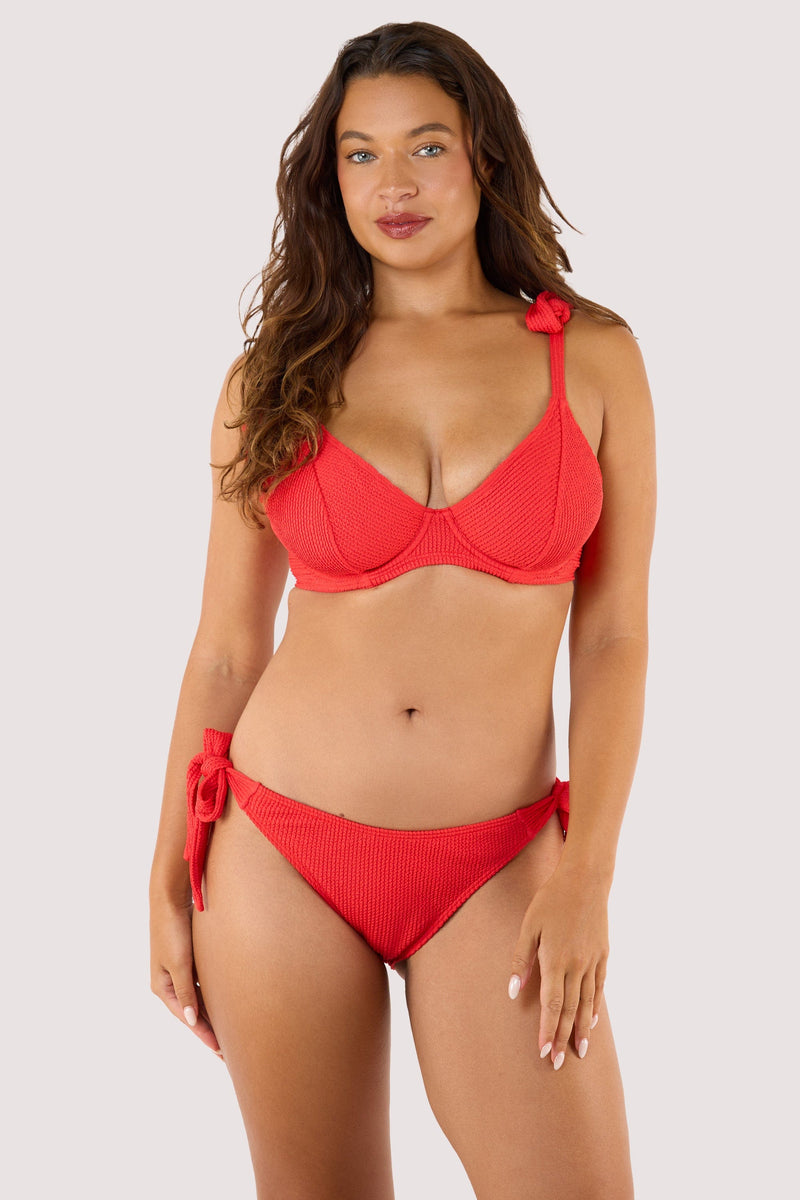 Model Wearing a red crinkle bikini top with a bow tie, designed for support with underwired cups and adjustable straps.