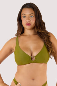 Model in a khaki bikini, featuring a plunging neckline and gold ring accent, perfect for a chic poolside look.