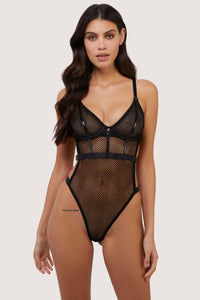 model wears Selena black high leg fishnet bodysuit