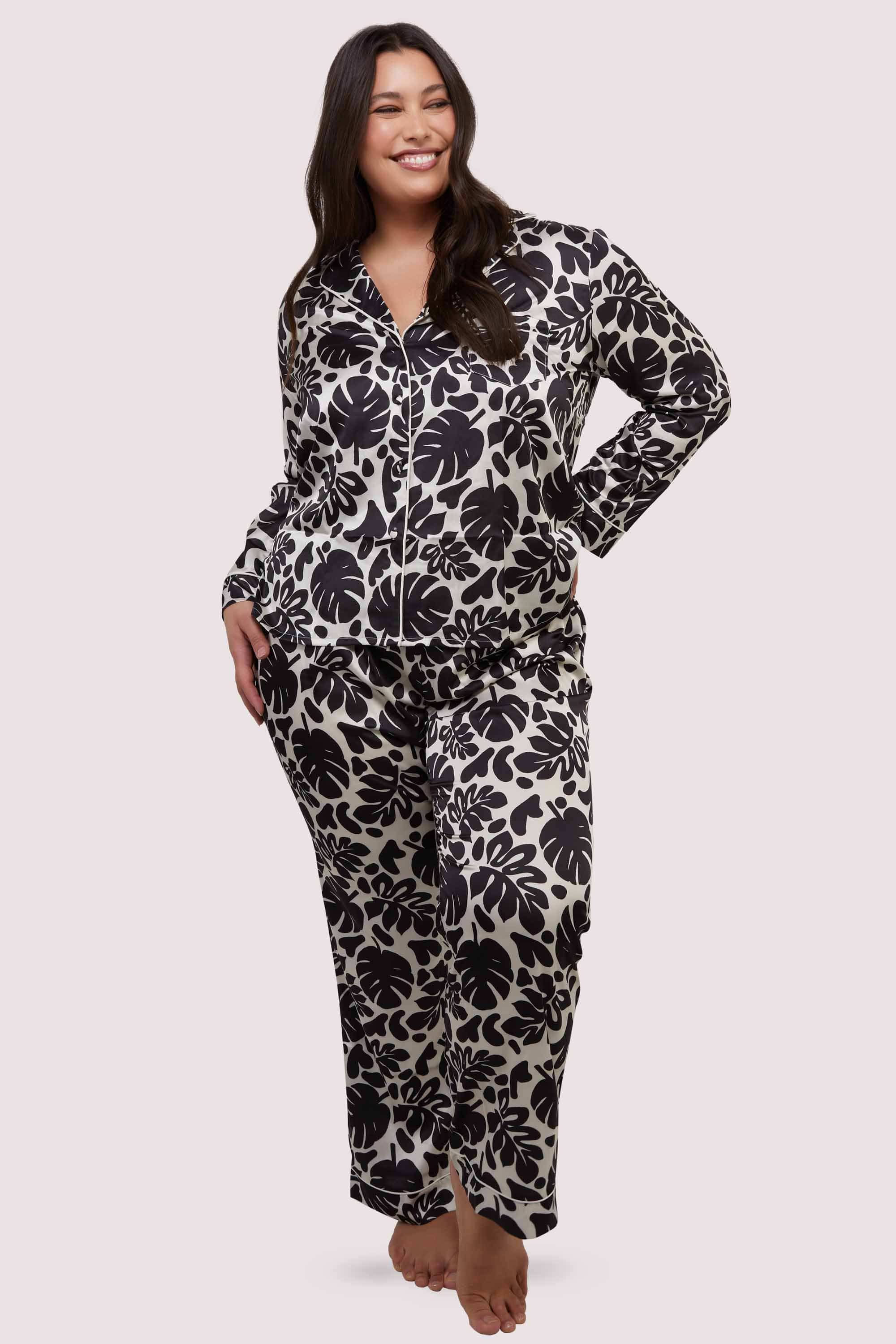 model wears black and white leaf print pyjamas