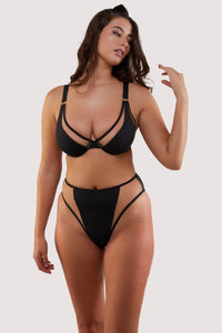 fuller bust model wears sexy black underwire bikini set with nude mesh inserts