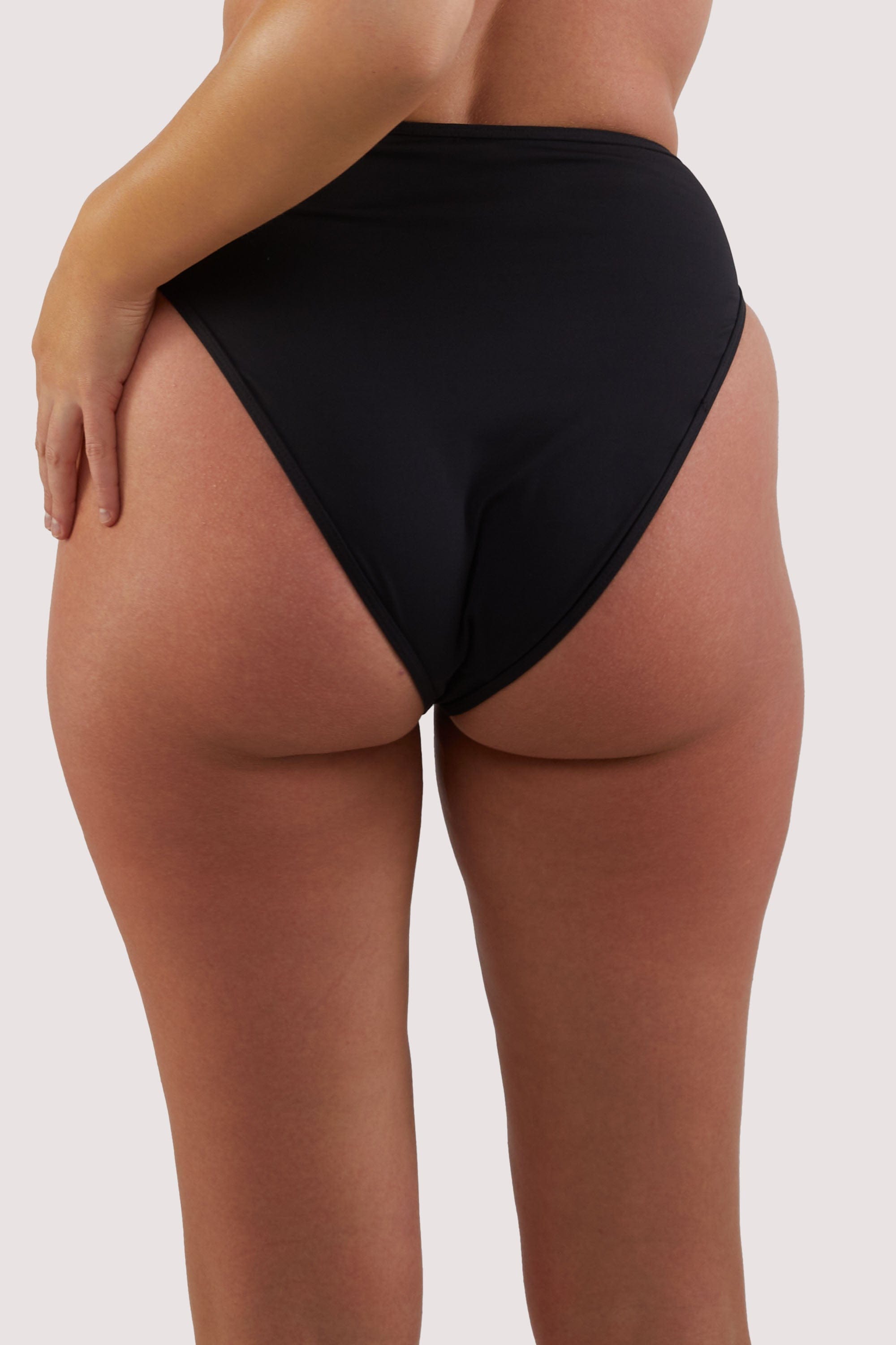 model shows full brief back of high-waist and high-leg bikini bottoms