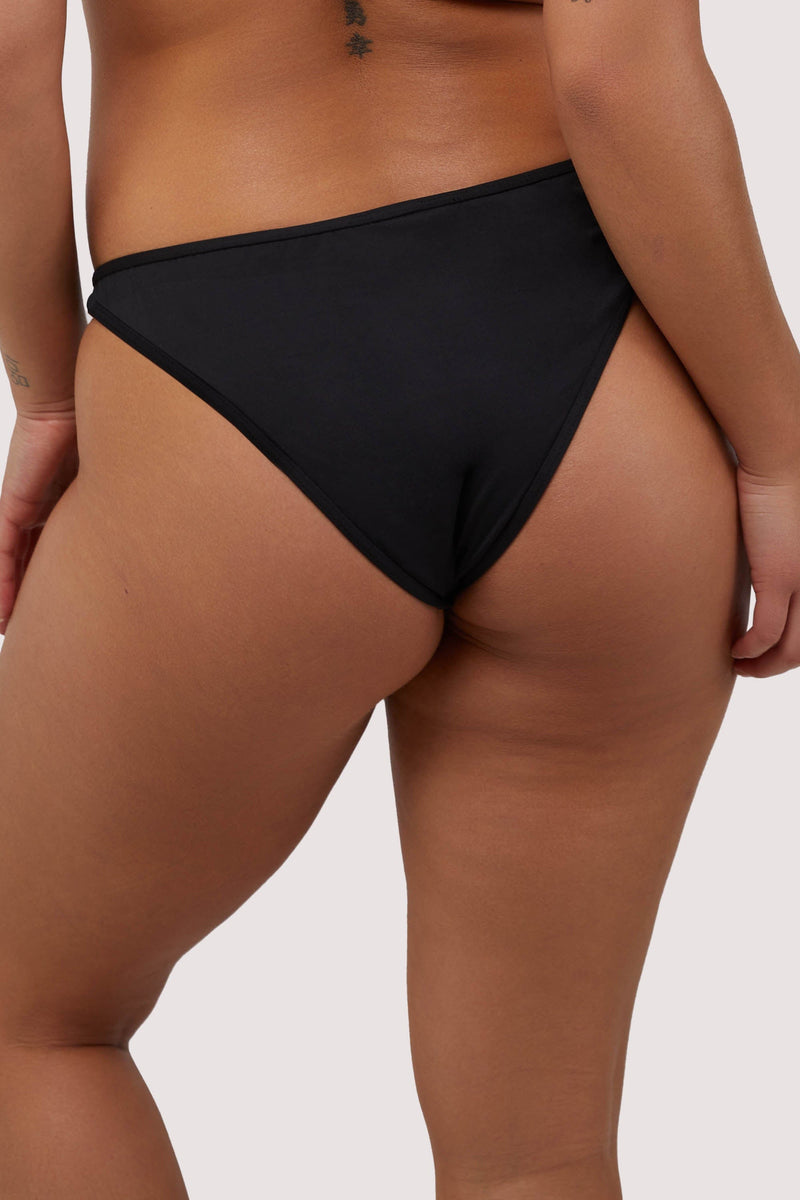 model shows full brief back of black and nude mesh bikini bottoms