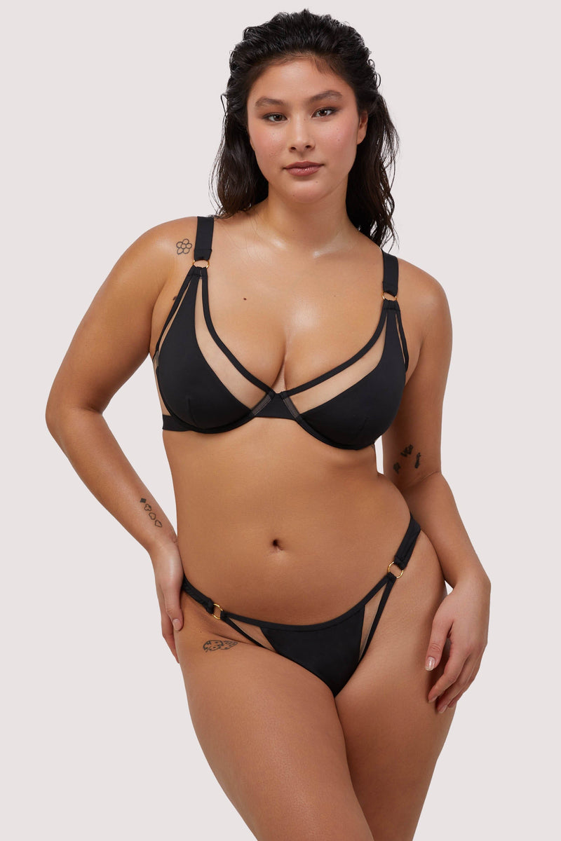 model wears sexy black bikini set with nude mesh panels and gold metal rings