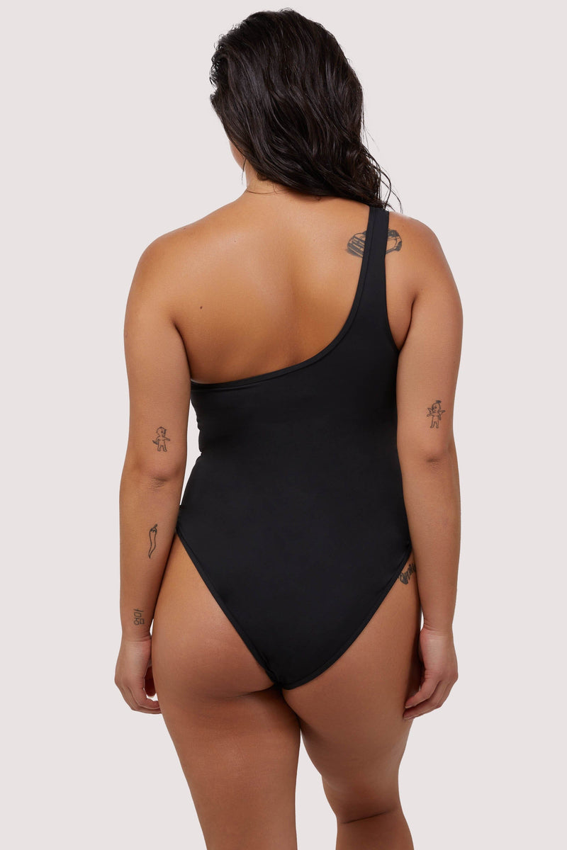 model shows full brief back of asymmetric black swimsuit
