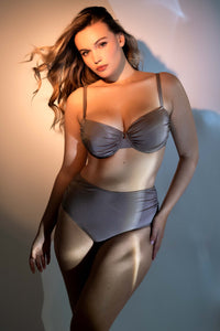 Model wears glistening taupe underwire bikini and high-waist brief set
