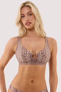 Model wears a raquel tiger print crop bikini top with tortoise shell ring and a crop top supportive style.