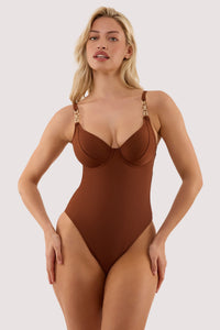 Model wears a tamzin chocolate brown underwired swimsuit with hardwear with underwire cup and a metal clasp fastening.