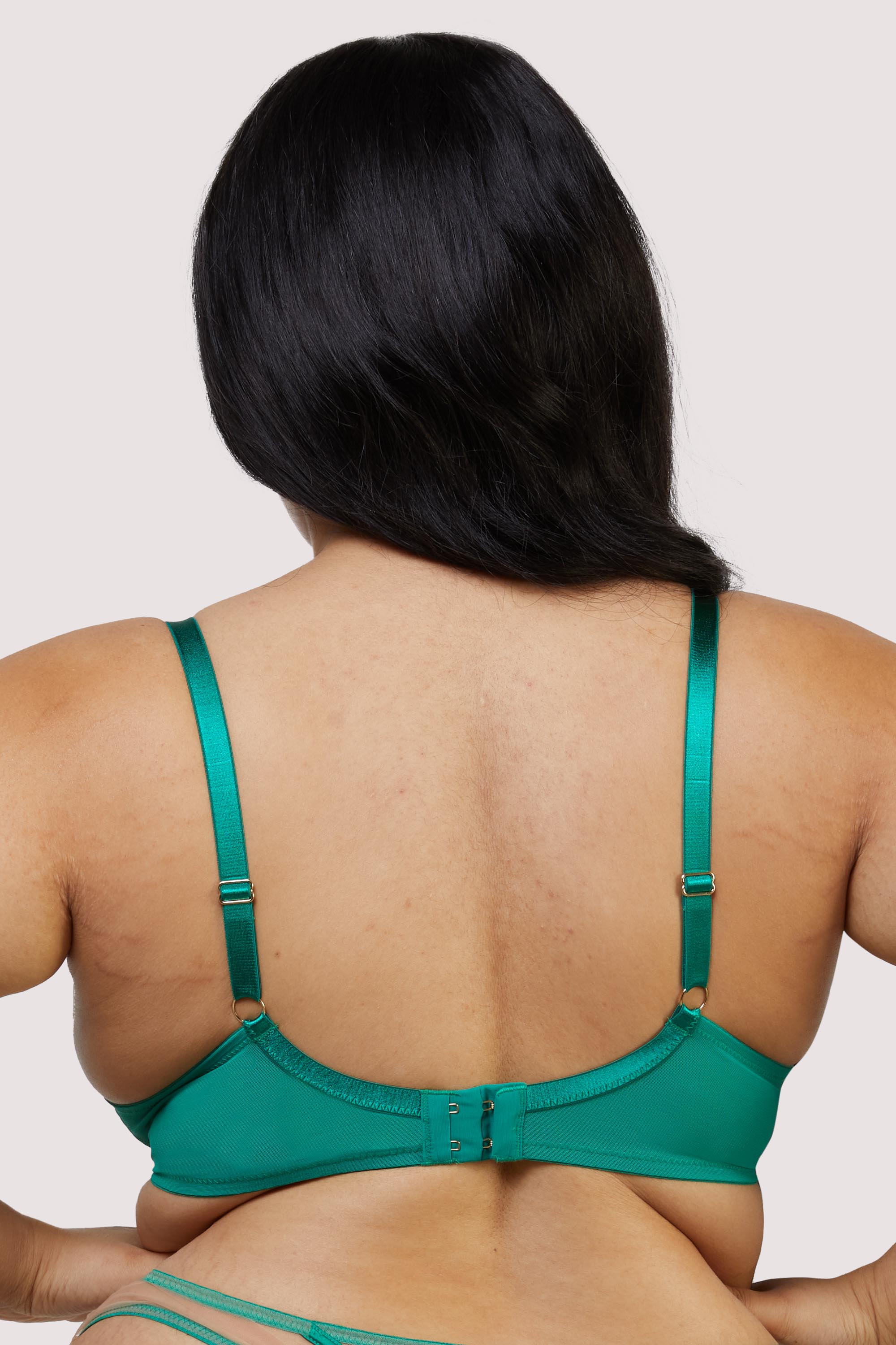 model shows the back of the green mesh plunge bra